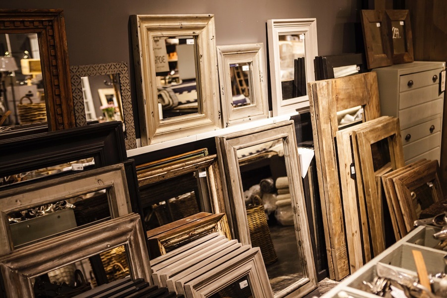 A selection of vintage mirrors on the floor of a store.